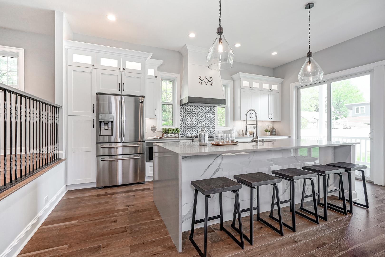 Counter in kitchen with designed backsplash tiles and under cabinet lighting